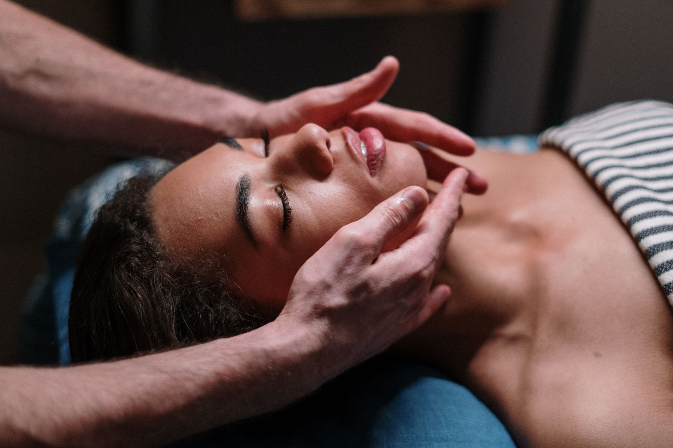 Facial massage in warm ambient light
