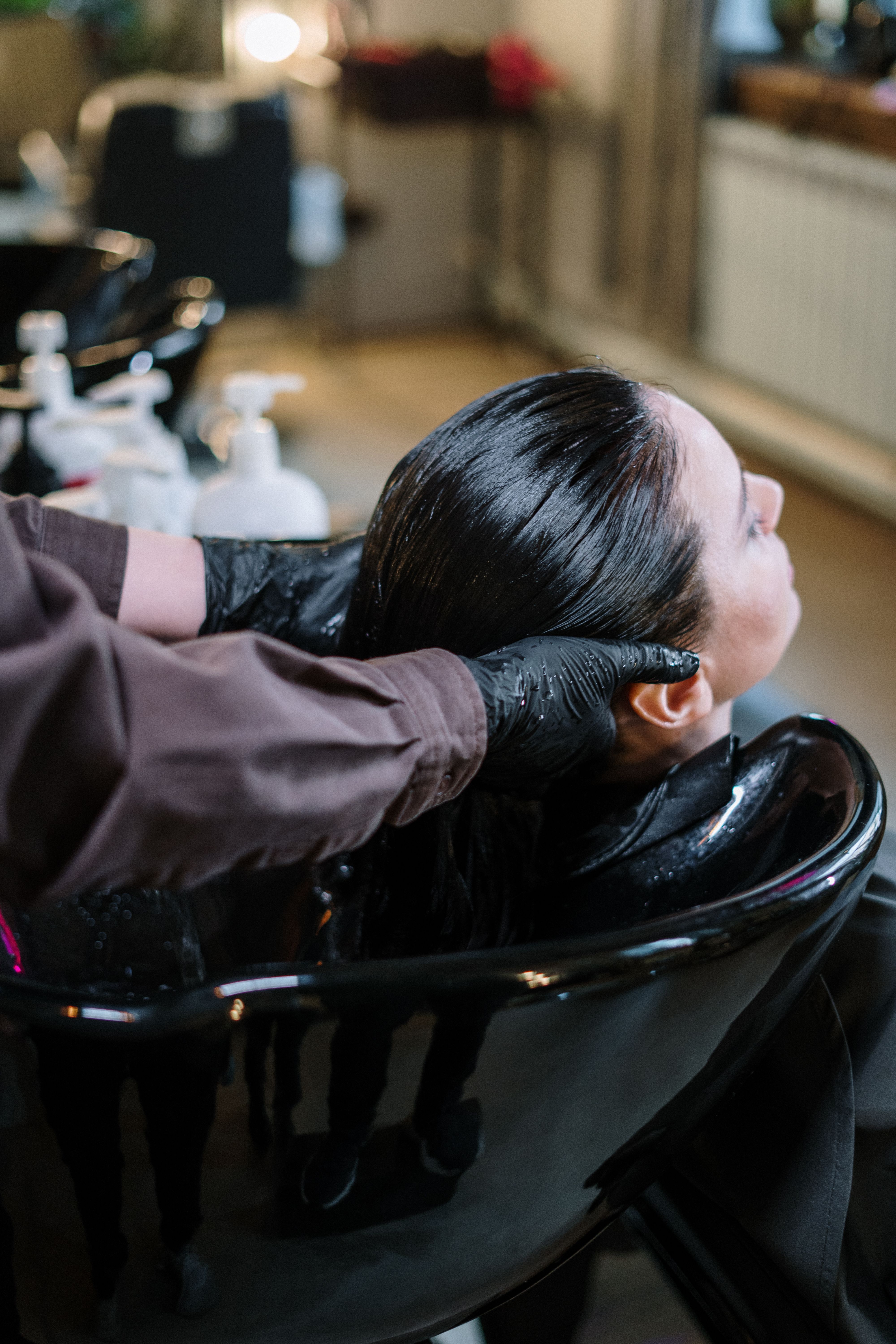 Scalp massage with gloves at the shampoo bowl