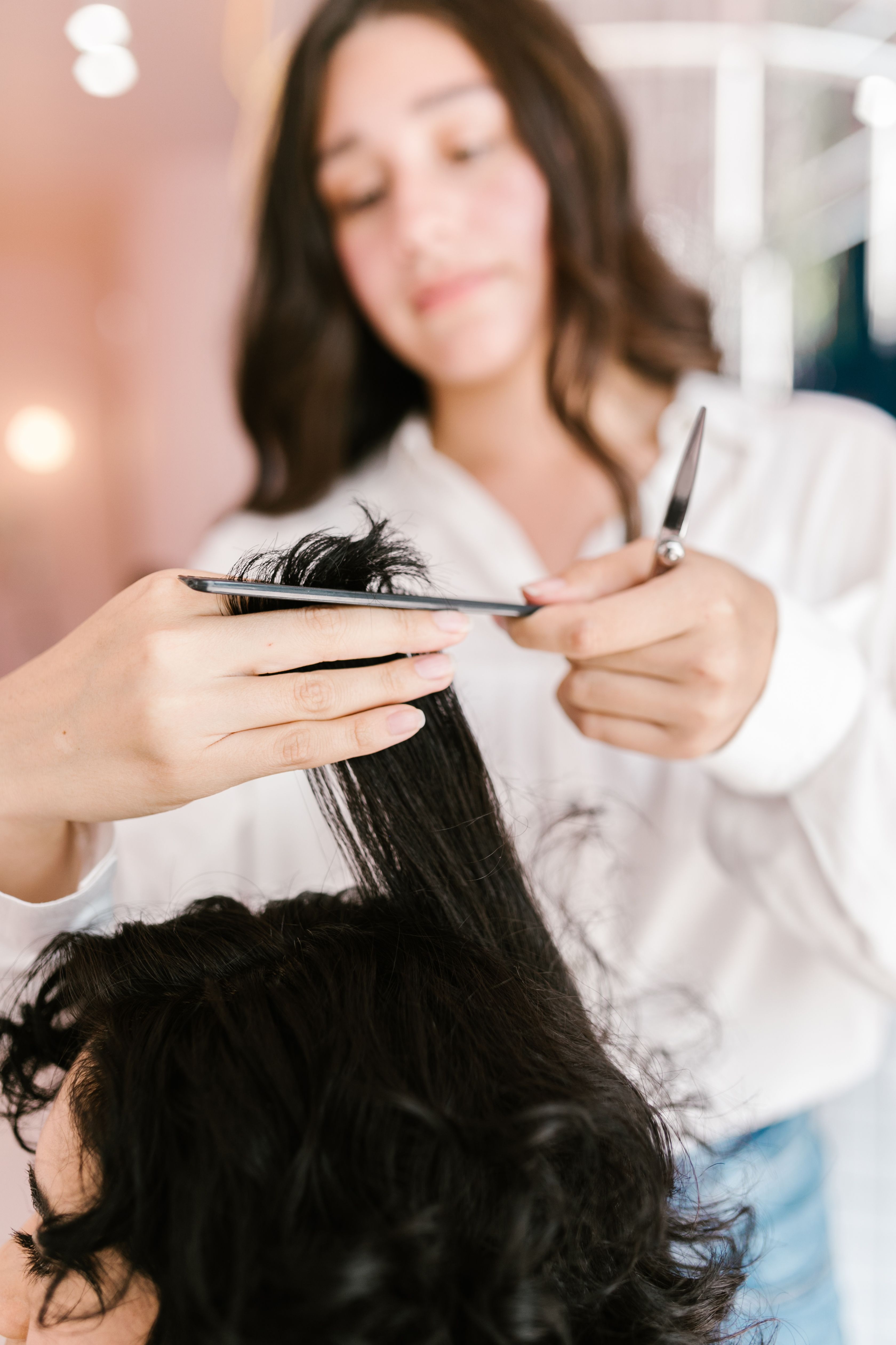 Stylist cutting hair with scissors