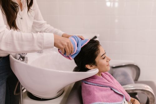 Hair wash at the shampoo bowl