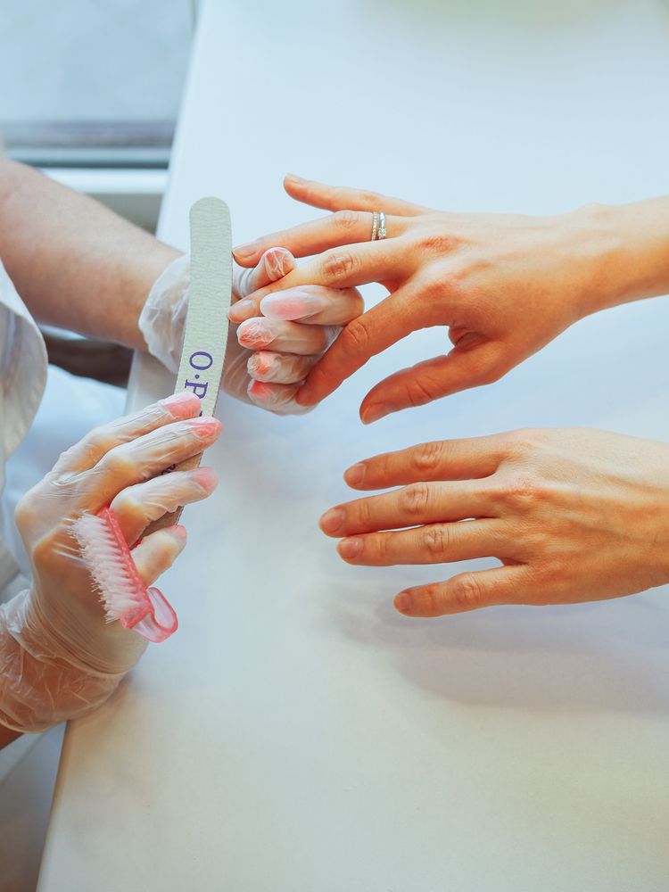 Filing nails at the manicure table